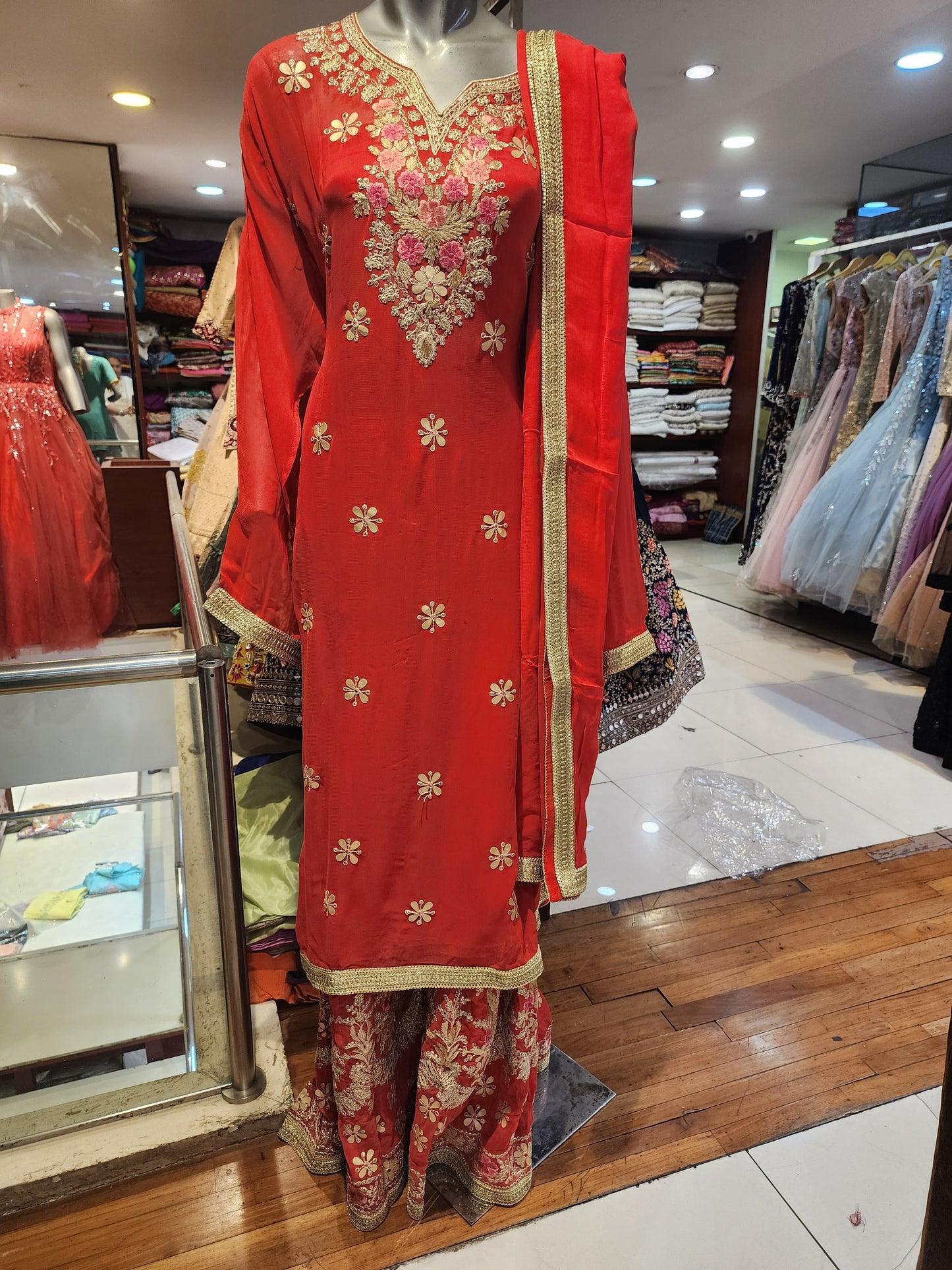 Red colour georgette semi stitch shirt with stitch sharara suit, gota patti + Jari + resham work with georgette dupatta