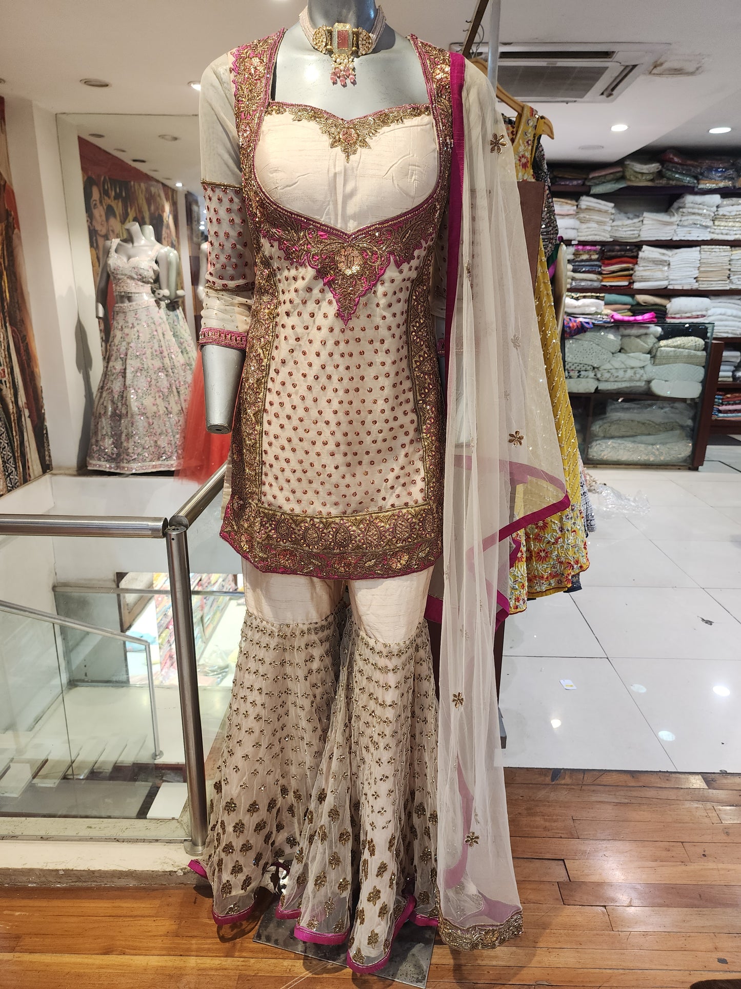 Golden colour net and raw silk heavy antique work garara suit