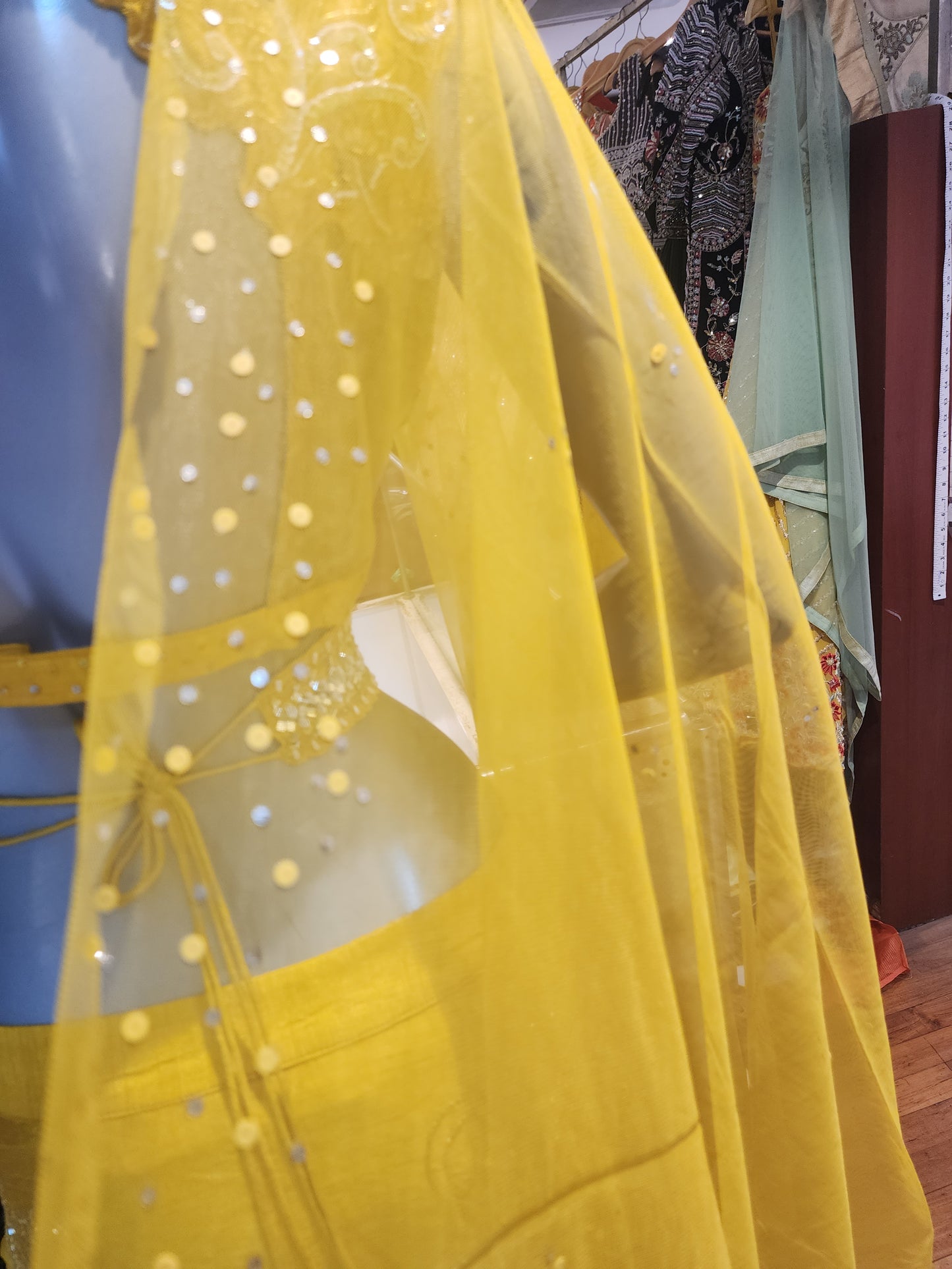 Yellow colour raw silk lahanga with net frill , hand work blouse, cut dana + pearl+ sequins + mirror work , with net dupatta