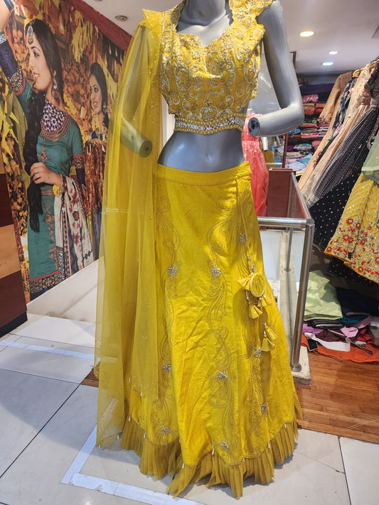 Yellow  colour raw silk lahanga with net frill  , hand work blouse, cut dana + pearl+ sequins + mirror work , with net dupatta