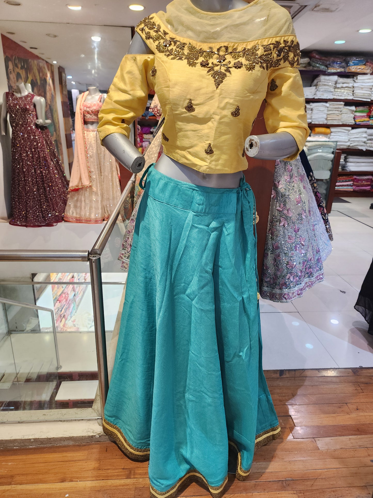 Semi silk firozi  lehenga with golden choli
