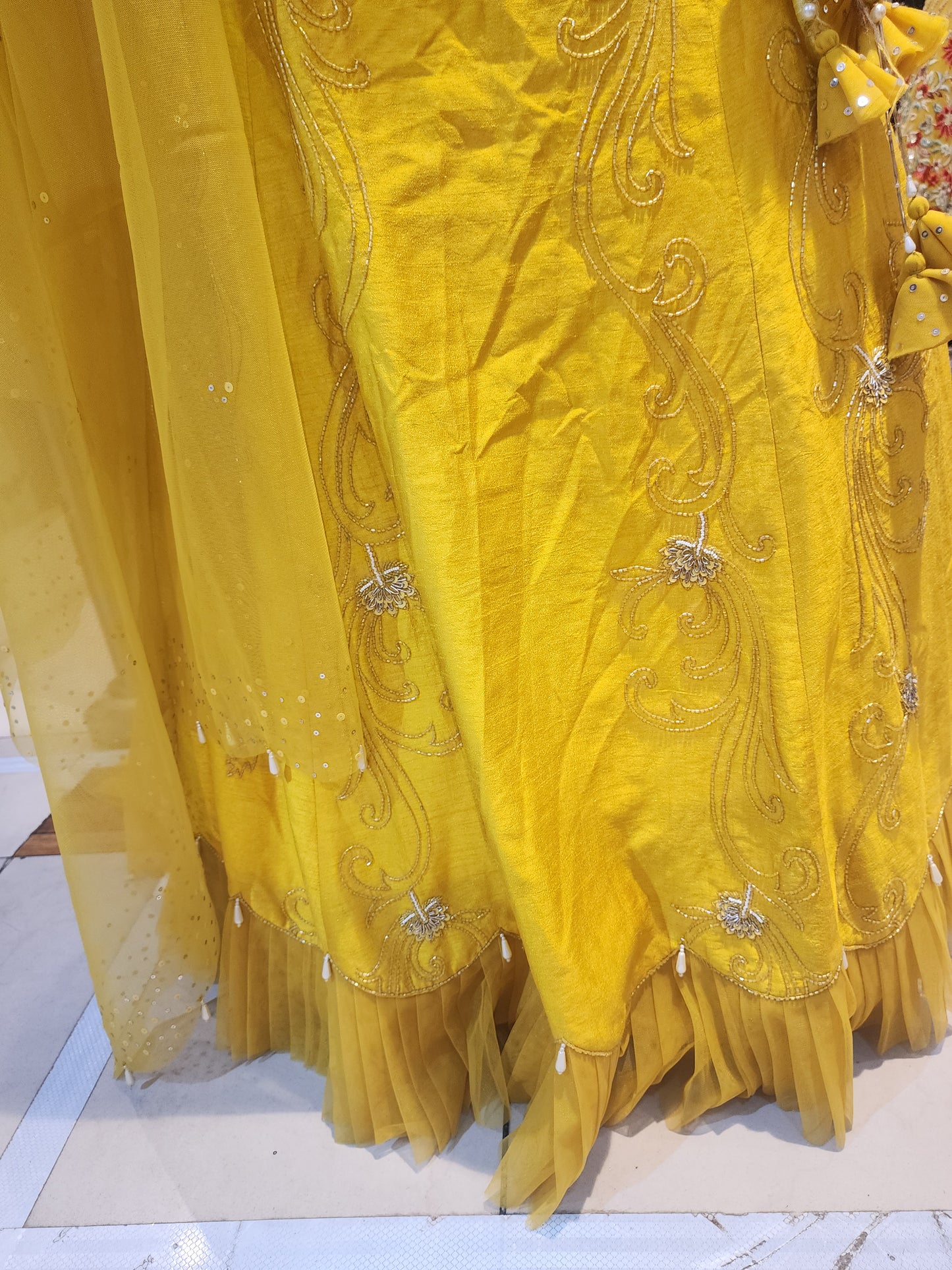 Yellow  colour raw silk lahanga with net frill  , hand work blouse, cut dana + pearl+ sequins + mirror work , with net dupatta