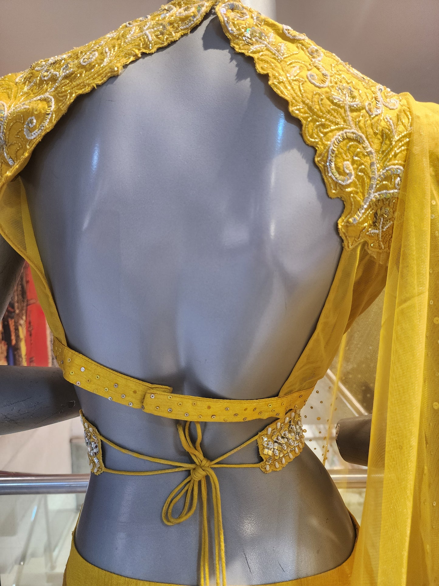 Yellow  colour raw silk lahanga with net frill  , hand work blouse, cut dana + pearl+ sequins + mirror work , with net dupatta