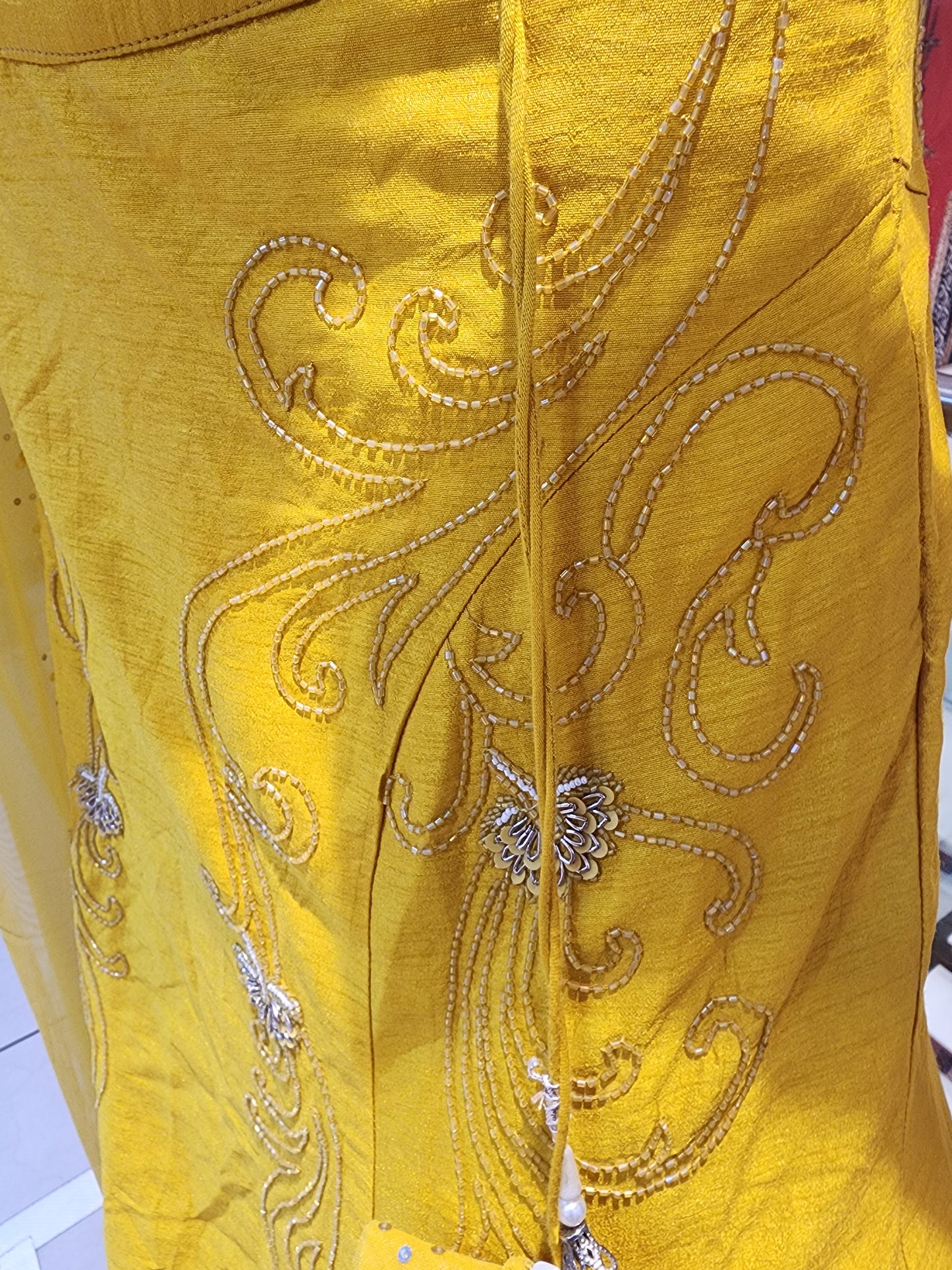 Yellow  colour raw silk lahanga with net frill  , hand work blouse, cut dana + pearl+ sequins + mirror work , with net dupatta