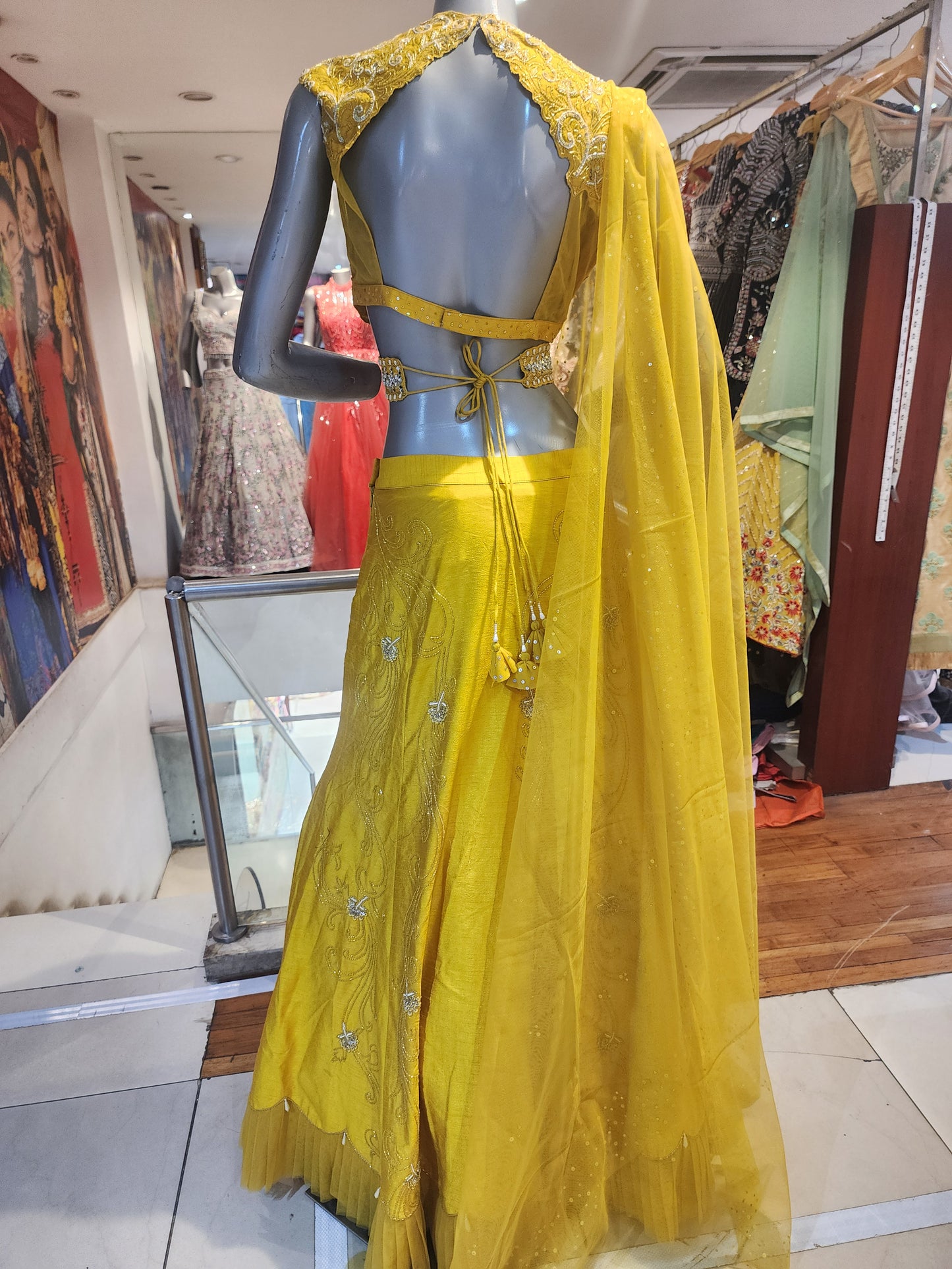 Yellow  colour raw silk lahanga with net frill  , hand work blouse, cut dana + pearl+ sequins + mirror work , with net dupatta