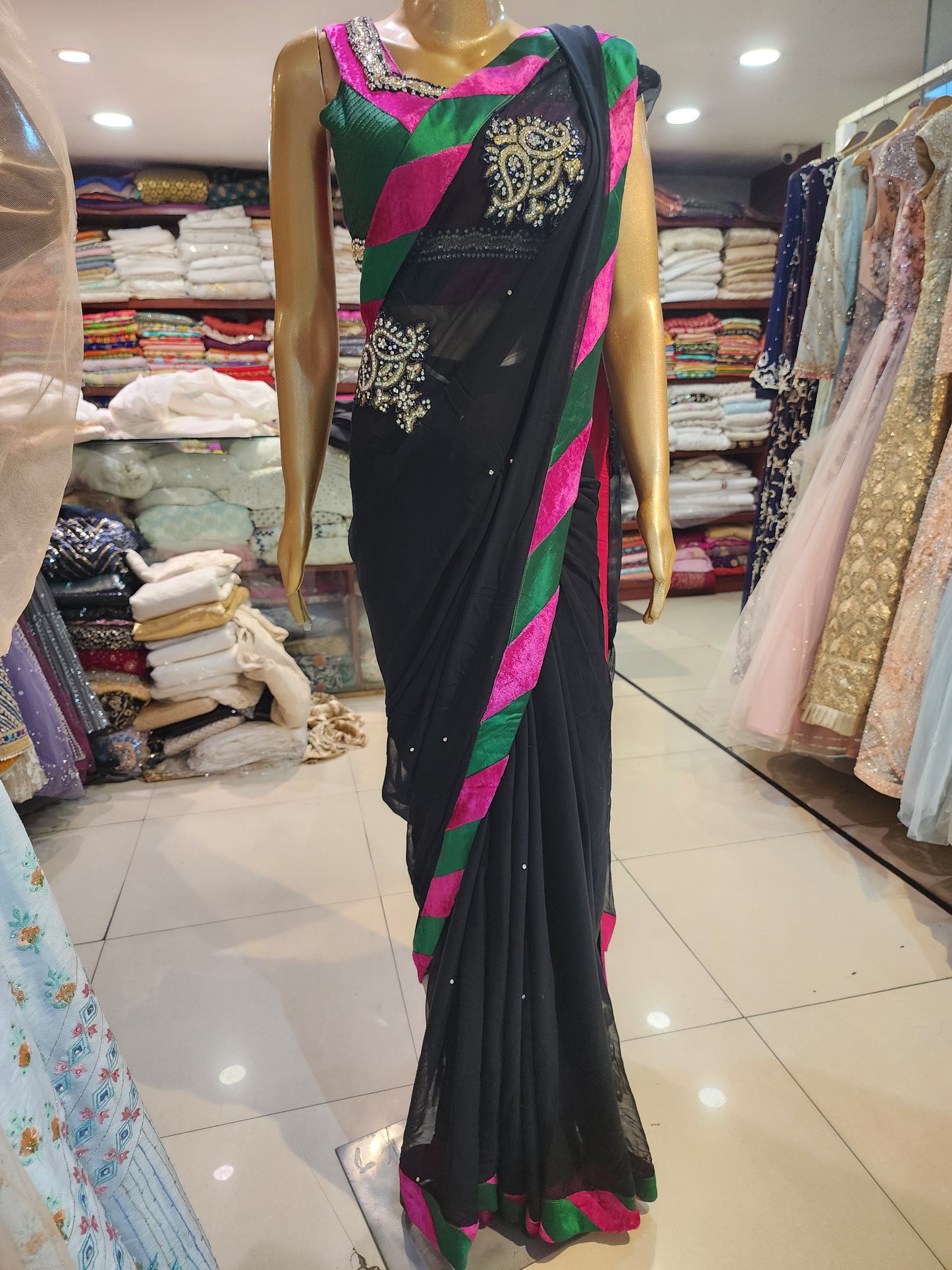 Black georgette saree with readymade  blouse , multicolored  velvet border and zerkan booti
